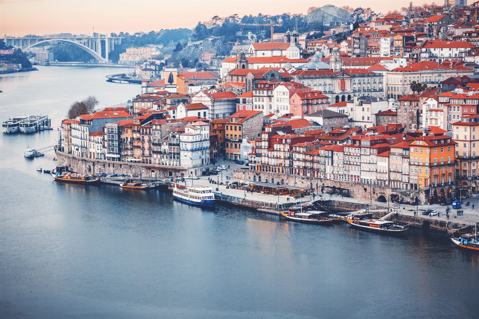 Porto’s riverfront houses climbing the hill above the Douro with boats moored below